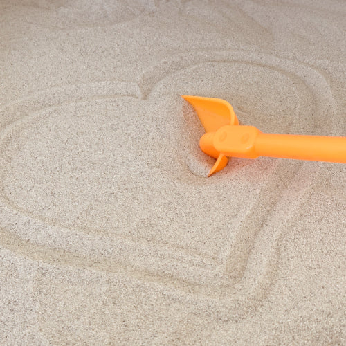 light colored california beach sand with a heart drawn in it and an orange pail