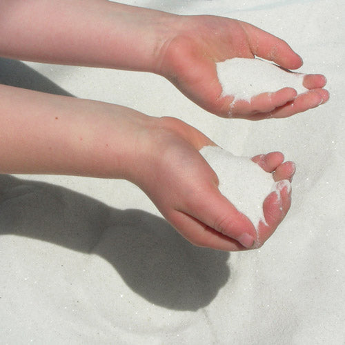 Closeup of child's hands holding Safe Sand White Play Sand